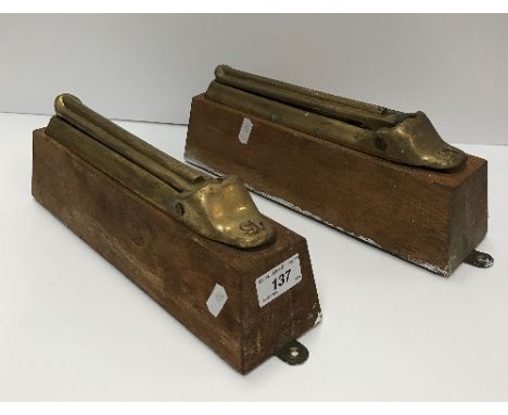 A pair of Victorian brass folding shelf wall brackets, inscribed "SP" to base, on oak mounts, 30.5 cm long overall, bracket /