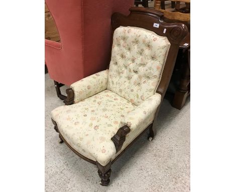 A Victorian mahogany framed salon armchair on carved and turned front legs to casters 96 cm high by 59 cm wide together with 