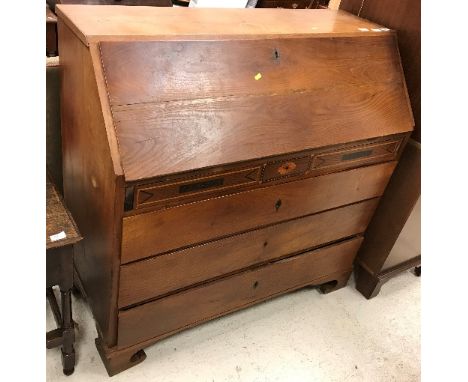 A George IV oak and inlaid bureau as a marriage piece the plain top over a sloping fall enclosing a parquetry inlaid interior