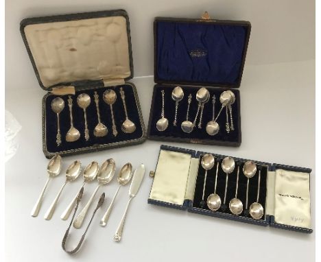 A cased set of six silver coffee bean spoons, a cased set of six silver Apostle spoons, a case containing a set of five Apost