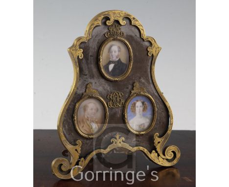 Three Victorian oil on ivory portrait miniatures of members of the Huggins family (Lion Brewery), housed in an ormolu easel f