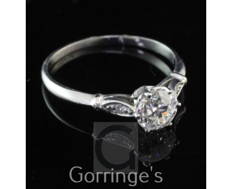 A platinum and single stone diamond ring with diamond set shoulders, the central stone weighing approximately 0.61ct, size L.