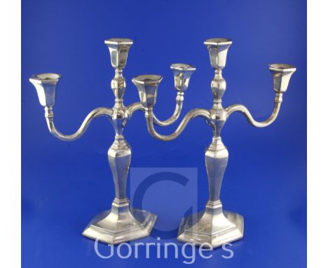 A pair of 20th century Chinese silver two branch, three light candelabra by Wai Kee, Hong Kong, with inverted baluster stems 
