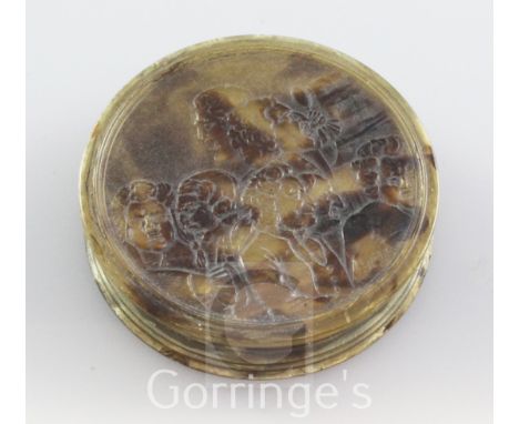 An 18th century blond tortoiseshell circular snuff box, embossed with a satirical scene relating to Handels opera Rinaldo, 3i
