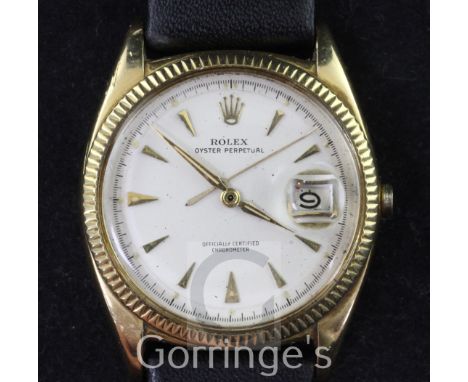A gentleman's 1950's/1960's 18ct gold Rolex Oyster Perpetual wrist watch, with milled bezel and arrow head numerals with date