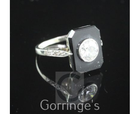 A 1930's/1940's 18ct white gold, onyx and single stone diamond tablet ring, of octagonal form, with diamond set shoulders, si