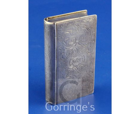 A mid 19th century continental silver double lidded snuff box, modelled as a book, with engraved initials and scrolling decor