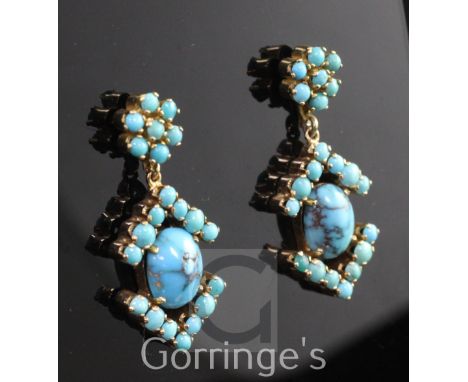 A pair of gold and turquoise set cluster drop earrings, with central cabochon stone and arrow terminals, 1.25in.