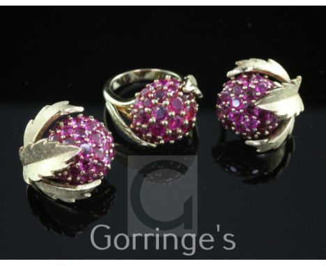 A modern 18ct gold and ruby cluster dress ring and a similar pair of gold ear clips, of domed form, with leaf shaped mounts, 