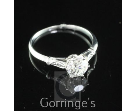 A white gold and single stone diamond ring, with diamond set shoulders, the central old cut stone weighing 0.74ct, size L.