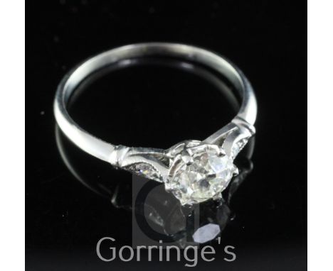 A white gold and single stone diamond ring, with diamond set shoulders, the central round old cut stone weighing approximatel