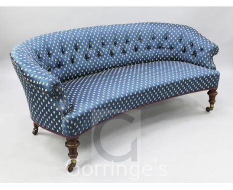 A Victorian walnut button back settee, with blue and gold fly motif upholstery, on fluted legs, W.5ft 8in.