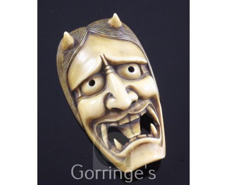 A Japanese Oni mask Manju netsuke, 19th century, with open mouth, engraved two character signature, 4.9cm