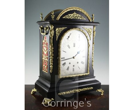 A Victorian style brass mounted ebonised chiming bracket clock, of architectural form, the arched silvered dial with chime si
