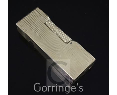 A 1960's 9ct gold Dunhill lighter, with engraved wavy decoration, hallmarks for Alfred Dunhill, London, 1967, in original Alf