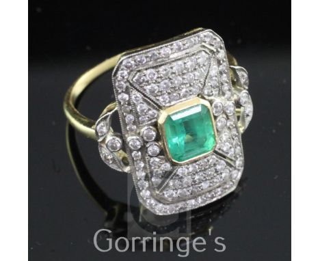 A mid 20th century Belle Epoque style gold, emerald and diamond tablet ring, of octagonal form, with central emerald cut ston