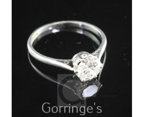 A platinum and solitaire diamond ring, the round brilliant cut stone weighing approximately 0.75-0.80cts, size M.