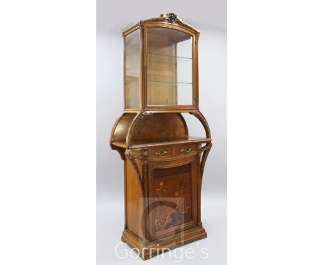 A Louis Majorelle 'Chicoree' pattern oak and marquetry display cabinet, with bevelled glazed door over an open shelf, single 