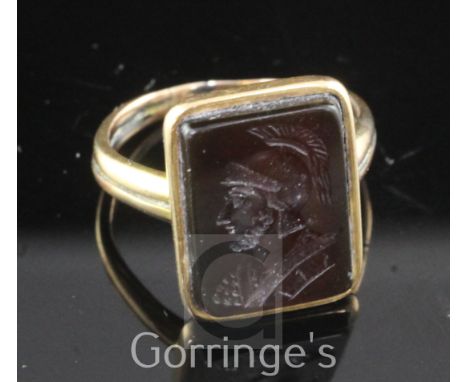 An antique gold and carnelian intaglio ring, of rectangular form, carved with the bust of a Roman Centurion to dexter, size O