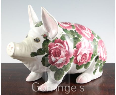 A large Wemyss cabbage rose pattern model of a seated pig, inscribed in green enamel Wemyss, length 43cm, restoration to snou