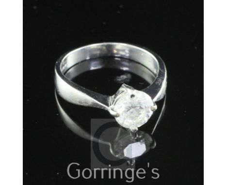 An 18ct white gold and solitaire diamond ring, the round cut stone weighing approximately 1.10ct, size M.