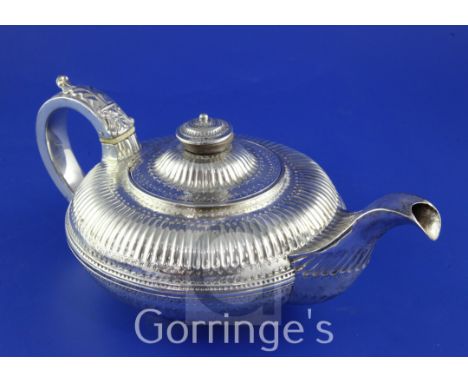 A George IV provincial silver teapot by Barber, Cattle & North, of squat circular form, with banded girdle and fluted decorat