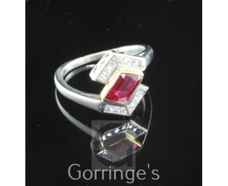 A stylish 18ct gold and platinum, ruby and diamond ring, the central 1.03ct ruby flanked by twelve fancy square cut diamonds 