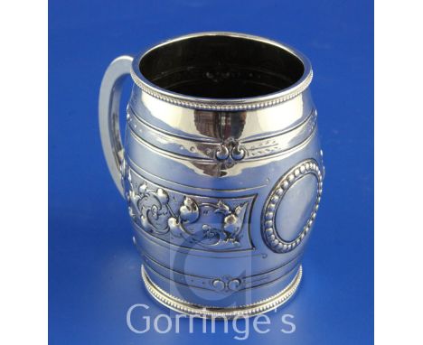 A Victorian silver barrel shaped christening mug, with beaded borders and embossed with foliate band, H.J. Lias & Son, London