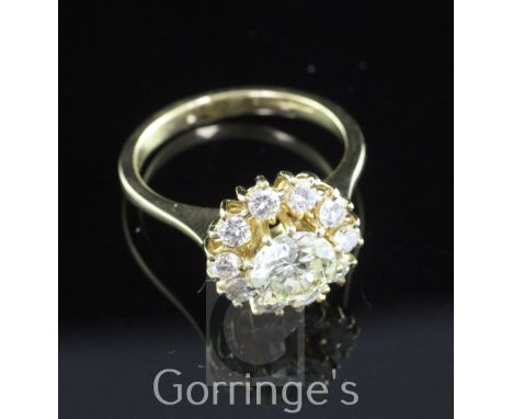 An Italian 18ct gold and diamond cluster ring, with central round brilliant cut diamond weighing approximately 1.00cts and br