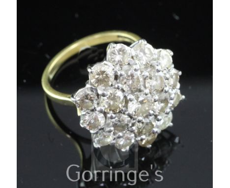 A late 1970's 18ct gold and diamond cluster ring, of flower head design, size O.