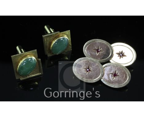 A pair of modern two colour 9ct gold and ruby oval cufflinks, with central star motif, gross weight 15.8 grams and a pair of 