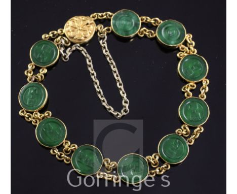 A Chinese high carat double chain link gold and jadeite bracelet, set with ten circular discs carved with Chinese characters,
