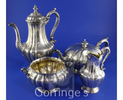 An early Victorian four piece silver tea and coffee set, of fluted baluster form, with melon shaped teapot and engraved with 