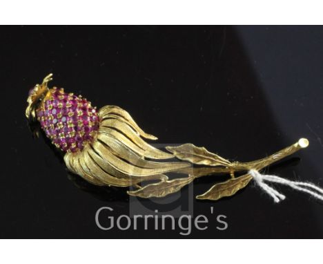 An 18ct gold and ruby trembleuse brooch modelled as an exotic fruit, set with cabochon and round cut stones, gross weight 14 