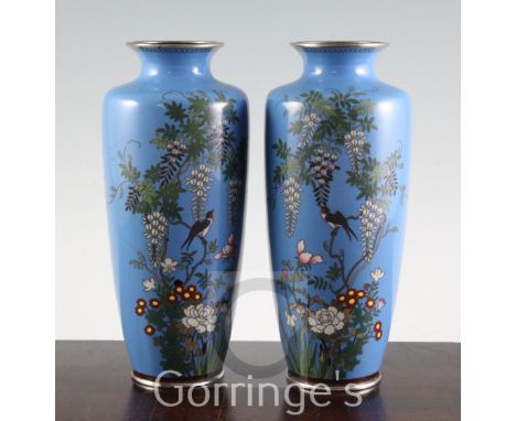 A pair of Japanese silver wire cloisonne enamel vases, early 20th century, each decorated with a bird amid trailing wisteria 