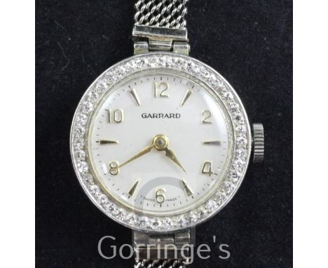 A lady's 1950's Swiss platinum and diamond set cocktail watch retailed by Garrard, with Arabic and baton dial and brilliant c