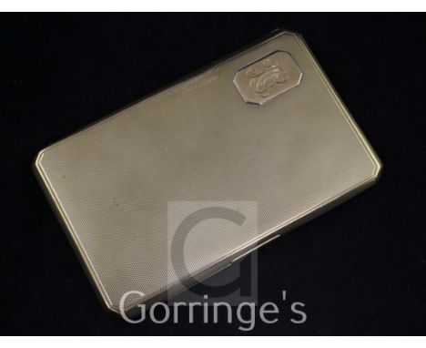 A George V engine turned 9ct gold cigarette case, of rectangular form, with canted corners and monogrammed appliqué, maker's,