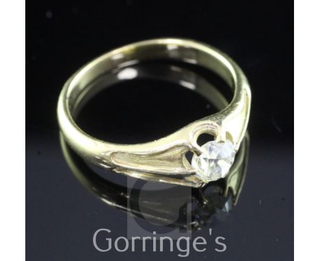 A gold and claw set solitaire diamond ring, with carved shoulders and old mine cut stone weighing approximately 0.45-0.50cts,