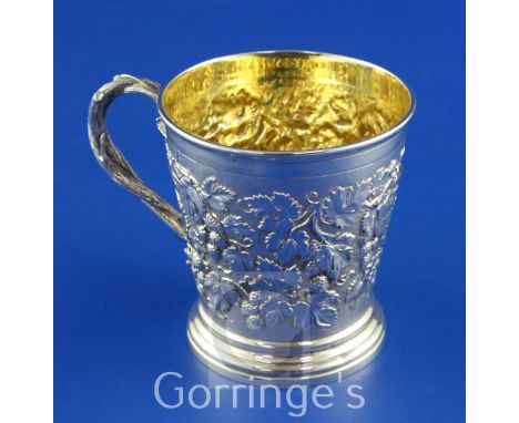 A Victorian silver christening mug by Hunt & Roskell, of tapering cylindrical form, with entwined rustic handle, engraved mon