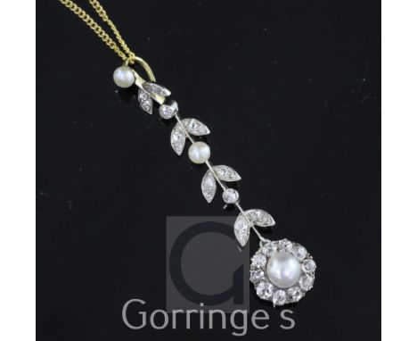An early 20th century gold, platinum, cultured pearl and diamond pendant, of foliate design, with flower head drop and set wi
