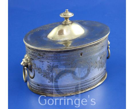 A late 19th/early 20th century Sheffield Plate oval two division tea caddy, with engraved foliate swags and geometric bands a