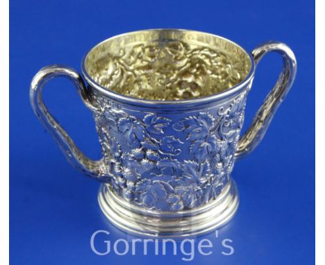 PAUL STORR. A good William IV silver loving cup, of tapering cylindrical form, with rustic loop handles and embossed with con