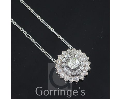 A Victorian gold, silver and diamond cluster sunburst pendant, with central cushion cut diamond weighing approximately 0.90-1