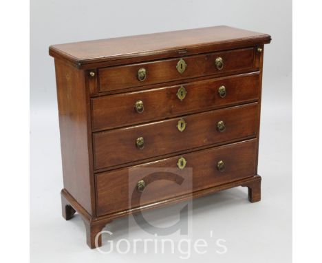 A George II red walnut bachelor's chest, with folding top resting on lopers over four graduated long drawers, fitted original