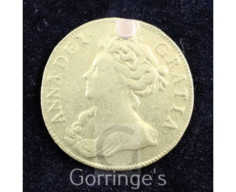 A Queen Anne gold guinea, 1702, first bust, plugged hole otherwise Fine