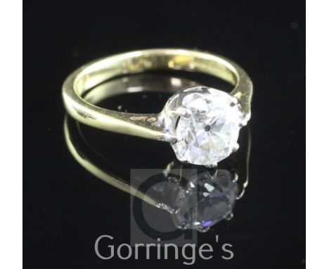 An 18ct gold and solitaire diamond ring, the old round cut stone weighing approximately 1.40-1.50cts, size L.