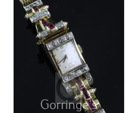 A lady's 1950's? gold, cabochon ruby and diamond set Frey cocktail watch, the rectangular dial with baton and quarterly Arabi