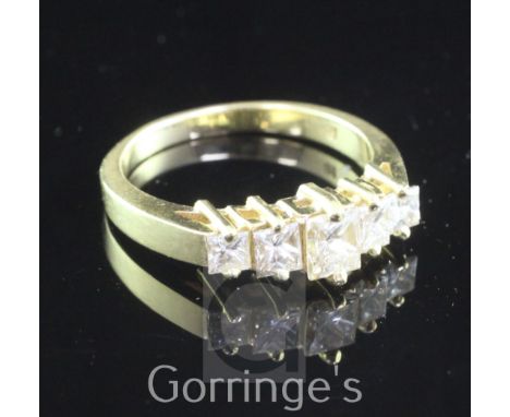 An 18ct gold and graduated five stone princess cut diamond half hoop ring, size P.