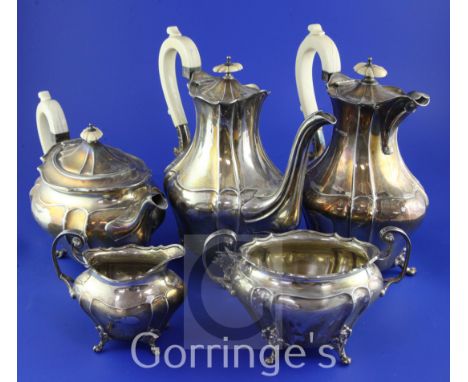 A late Victorian and Edwardian silver five piece tea and coffee service by James Dixon & Sons, of oval bombe shape, with ivor