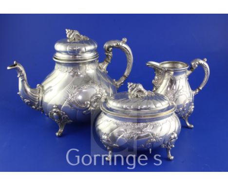 A late 19th century German 800 standard matched silver three piece tea set, of baluster form, with oval sugar box and spiral 